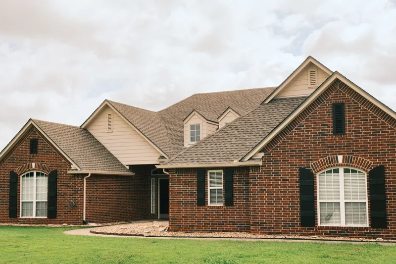 Completed shingle roof on a large brick home