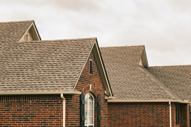 Roof gable and ridge line above a brick home