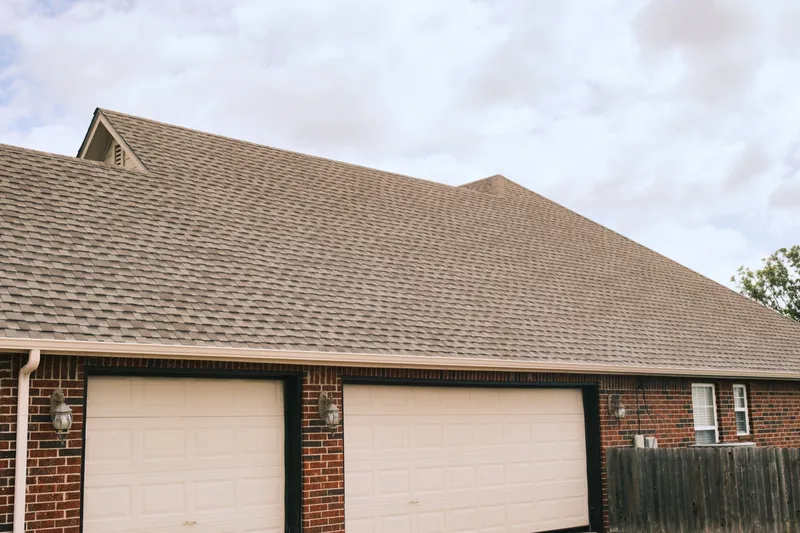 Completed roof and gable vent above an attached garage
