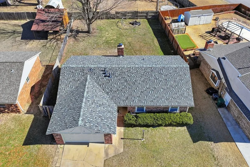 Aerial view of a completed shingle roof on a Tulsa area ranch home