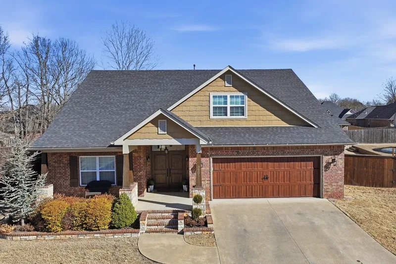 Completed shingle roof on a craftsman style home with a brick and shake front
