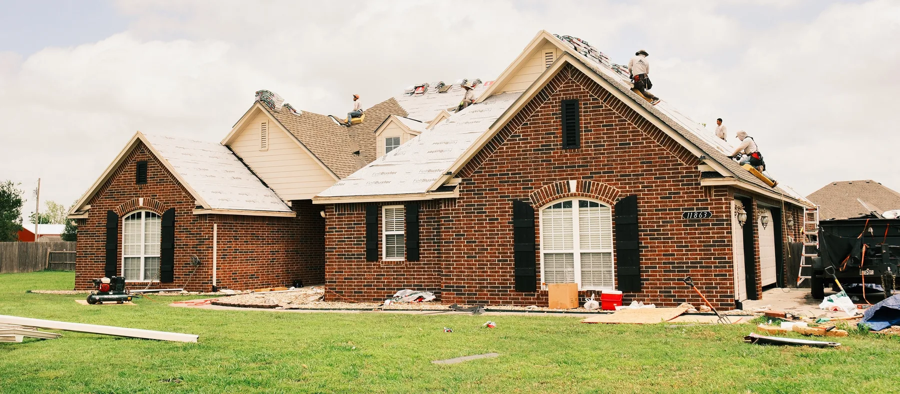 R&R Roofing crew replacing the roof on a brick home in the Tulsa metro