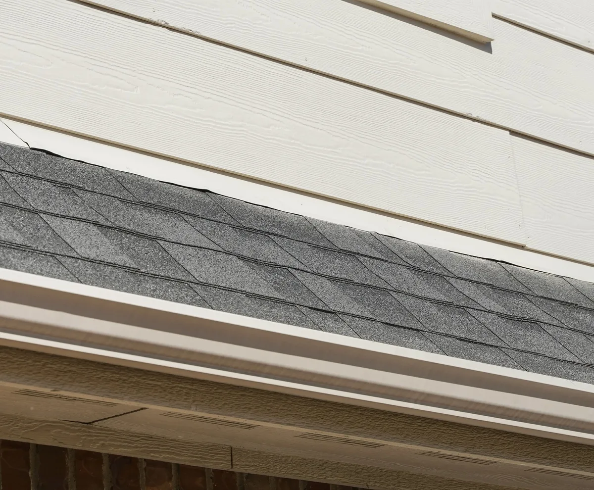 Continuous seamless gutter running the full length of a roof eave with no joints or seams